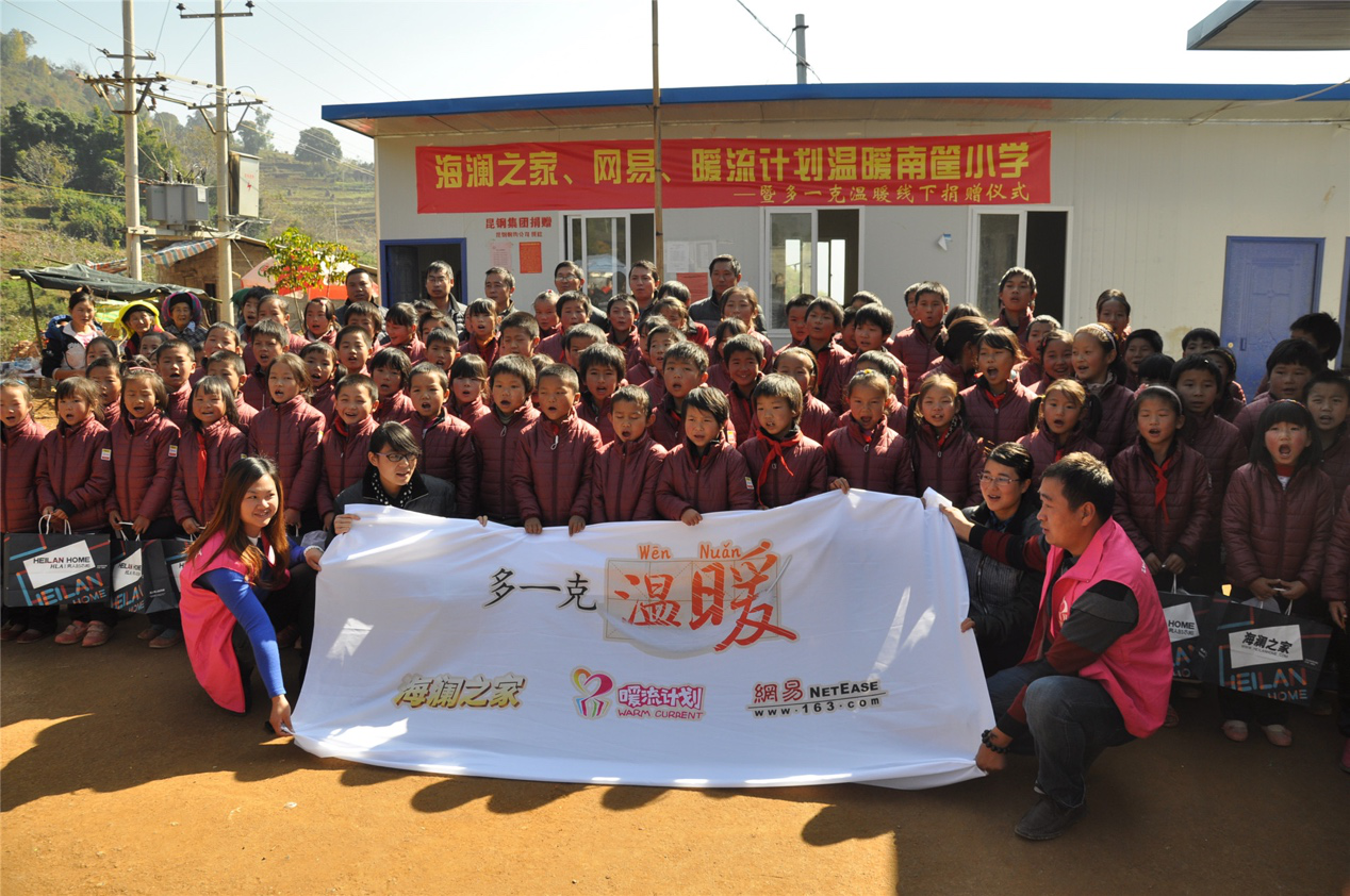 2014年11月20日，“多一克溫暖”公益團隊來到8.3大地震的重災區(qū)——云南省昭通市魯?shù)榭h的南筐小學。越過崎嶇山路，將一批又一批暖心羽絨服送到了師生們的手中，也將社會的關懷和愛意傳遞給了這些可愛的人。